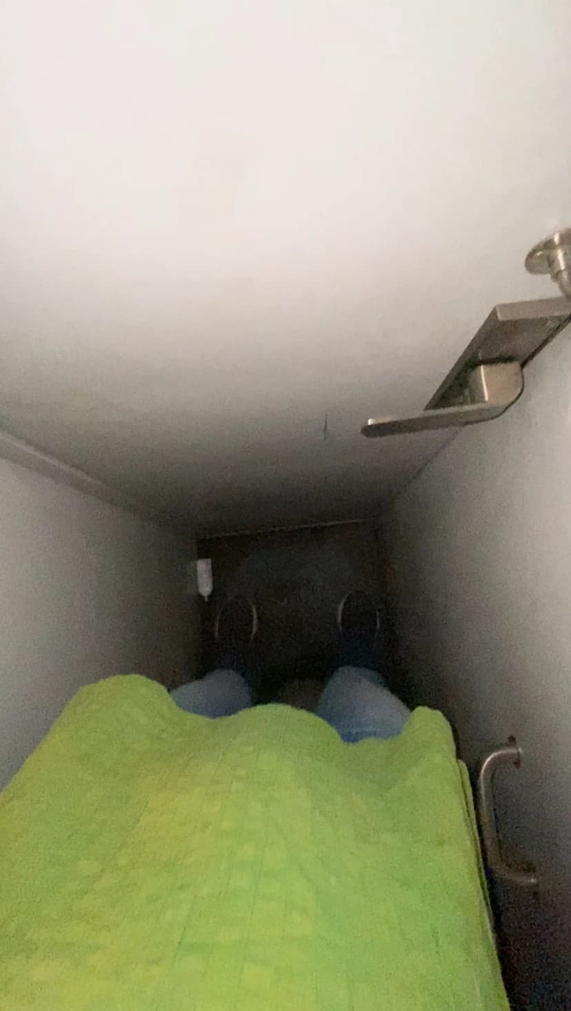 A point-of-view shot crouched inside the unit, knees close to the opposite wall