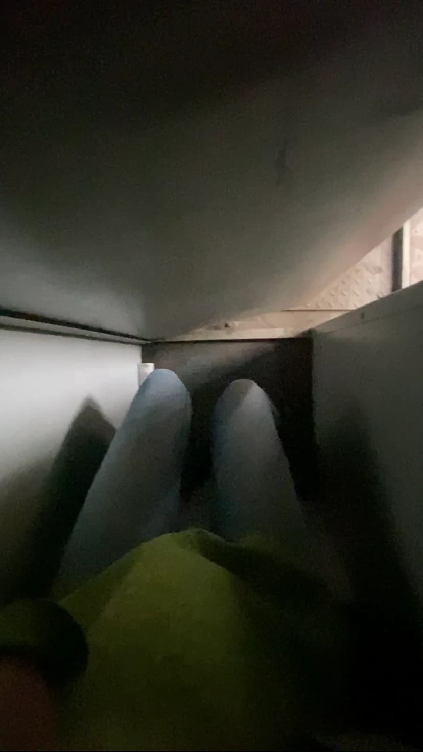 A closer point-of-view shot crouched inside the unit, the walls close on both sides